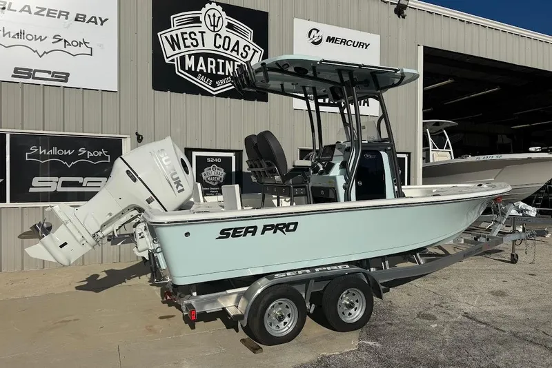 Slide: The Image of 2026 Sea Pro 210 Bay boat on trailer at West Coast Marine dealership. - 5