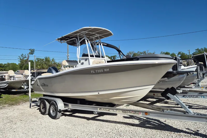 The Image of 2017 NauticStar 2102 Legacy boat on trailer under clear blue sky. - 0