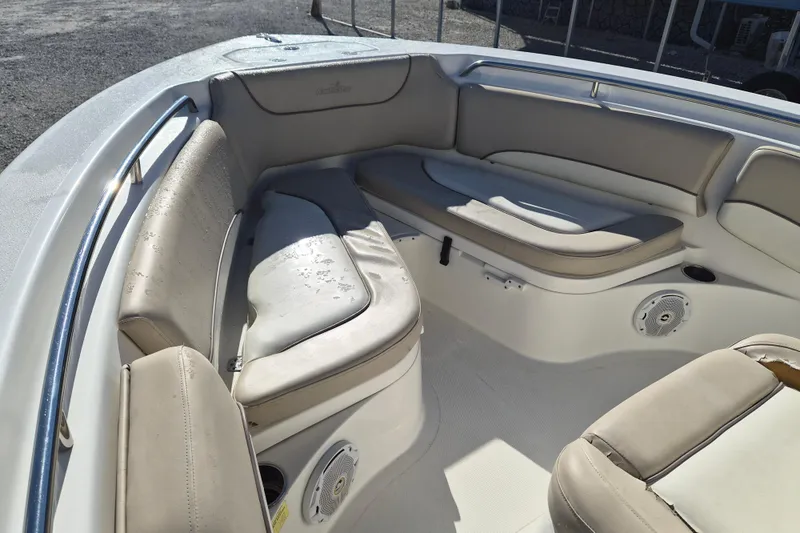Slide: The Image of Interior seating of 2017 NauticStar 2102 Legacy boat with beige cushions. - 10