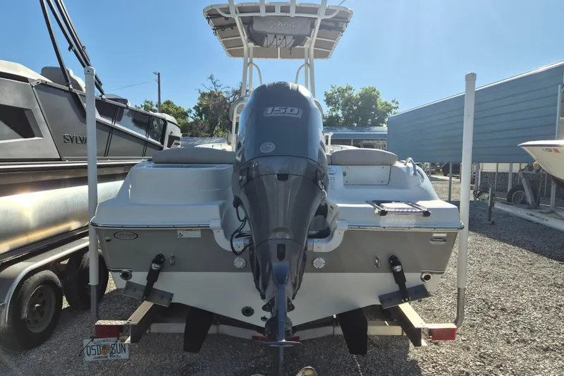 Slide: The Image of 2017 NauticStar 2102 Legacy boat with outboard motor in a storage area. - 2