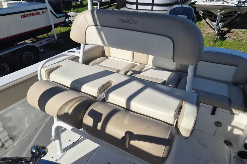 Slide: The Image of 2017 NauticStar 2102 Legacy boat seating area with beige upholstery. - 6