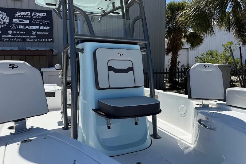 Slide: The Image of 2026 Sea Pro 230 Bay boat interior with seating and console, outdoor setting. - 4