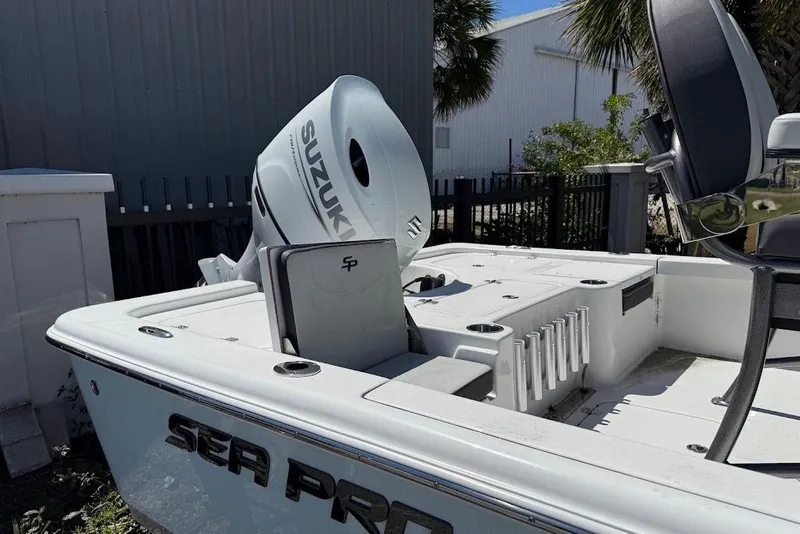 Slide: The Image of 2026 Sea Pro 230 Bay boat with Suzuki outboard motor, docked outdoors. - 5