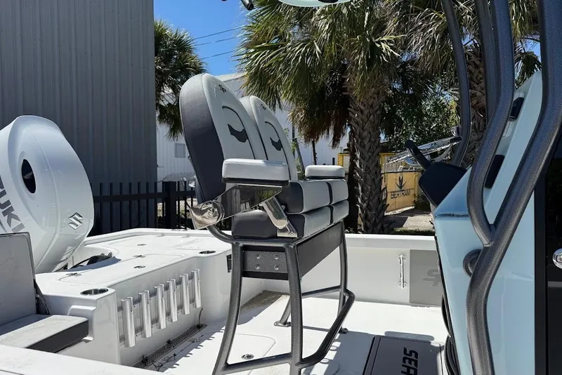 Slide: The Image of 2026 Sea Pro 230 Bay boat interior with seating and Suzuki engine. - 6
