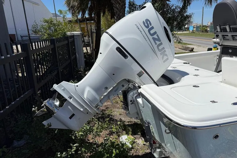 Slide: The Image of 2026 Sea Pro 230 Bay boat with Suzuki outboard motor, parked outdoors. - 7