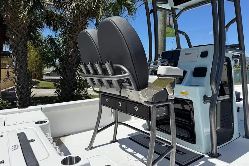Slide: The Image of 2026 Sea Pro 230 Bay boat interior with seating and console, under sunny skies. - 8
