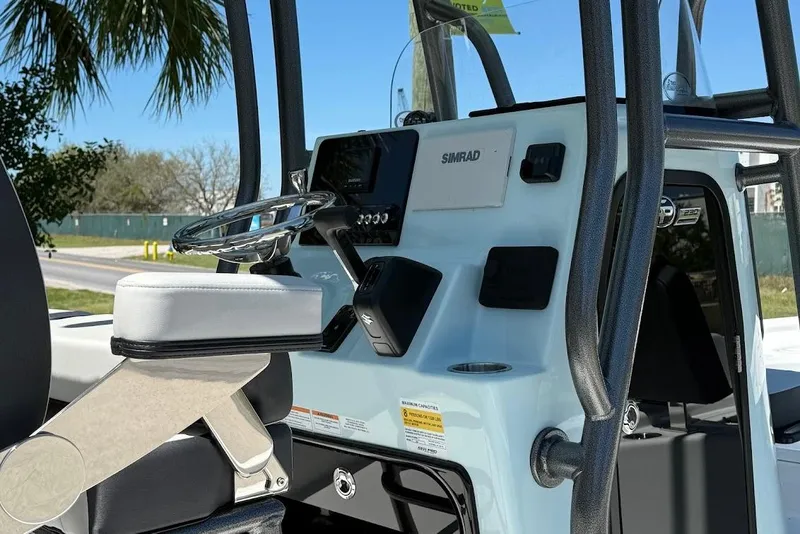 Slide: The Image of 2026 Sea Pro 230 Bay boat console with steering wheel and Simrad electronics. - 9