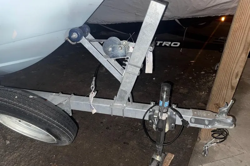 Slide: The Image of Trailer hitch of a 2022 Boston Whaler 130 Super Sport boat, parked indoors. - 1