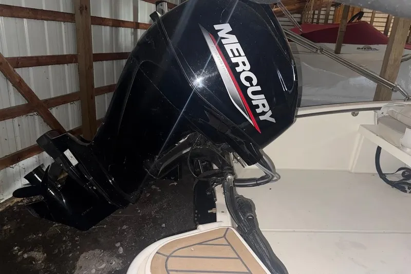 Slide: The Image of 2022 Boston Whaler 130 Super Sport with Mercury outboard engine in storage. - 12