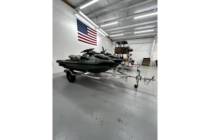 Slide: The Image of 2023 Sea-Doo GTX Limited 300 jet ski on trailer in garage with American flag. - 6