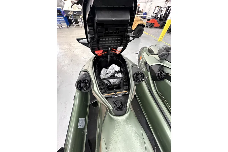 Slide: The Image of 2023 Sea-Doo GTX Limited 300 with open storage compartment in a workshop setting. - 7