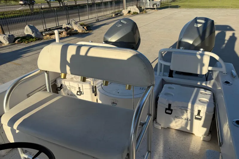 Slide: The Image of 2007 Twin Vee 26 Center Console boat interior with seating and dual engines. - 11