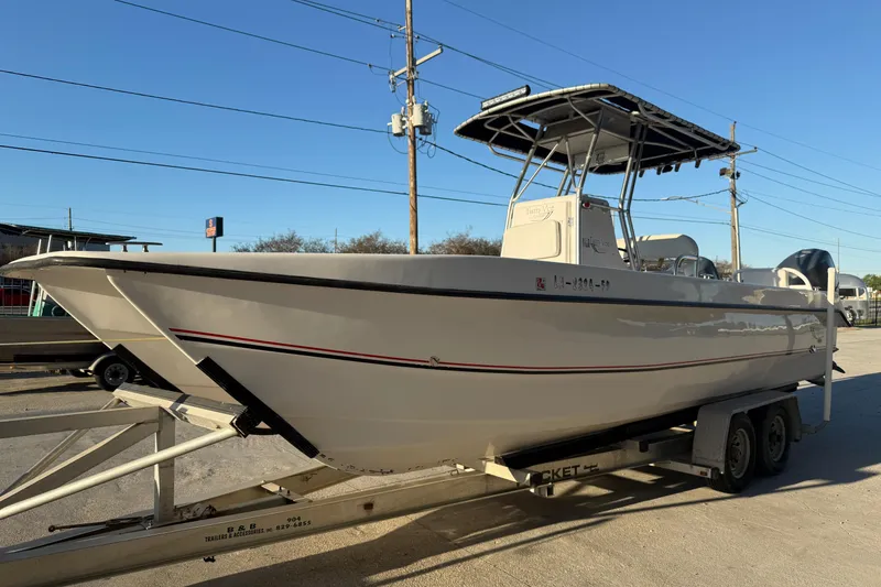 Slide: The Image of 2007 Twin Vee 26 Center Console boat on trailer, parked outdoors. - 5