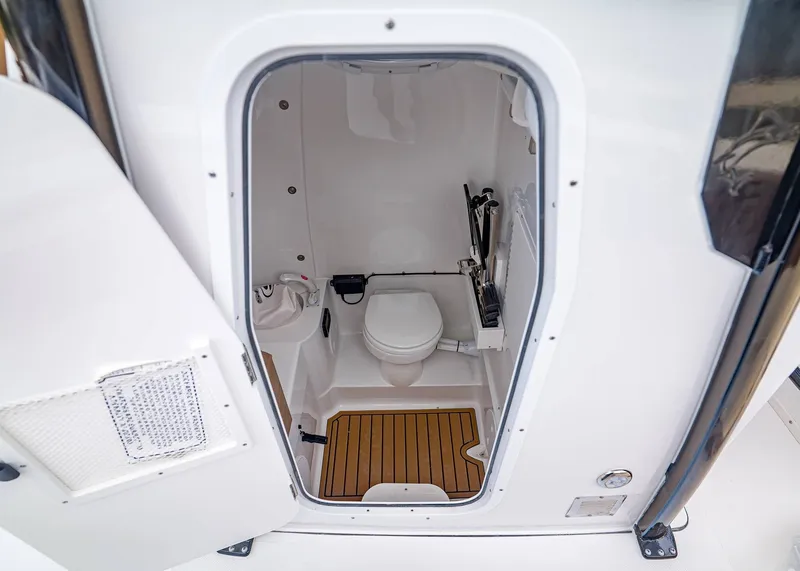 Slide: The Image of Interior view of the toilet on the Sea Hunt ULTRA 305 CB 2026. - 23