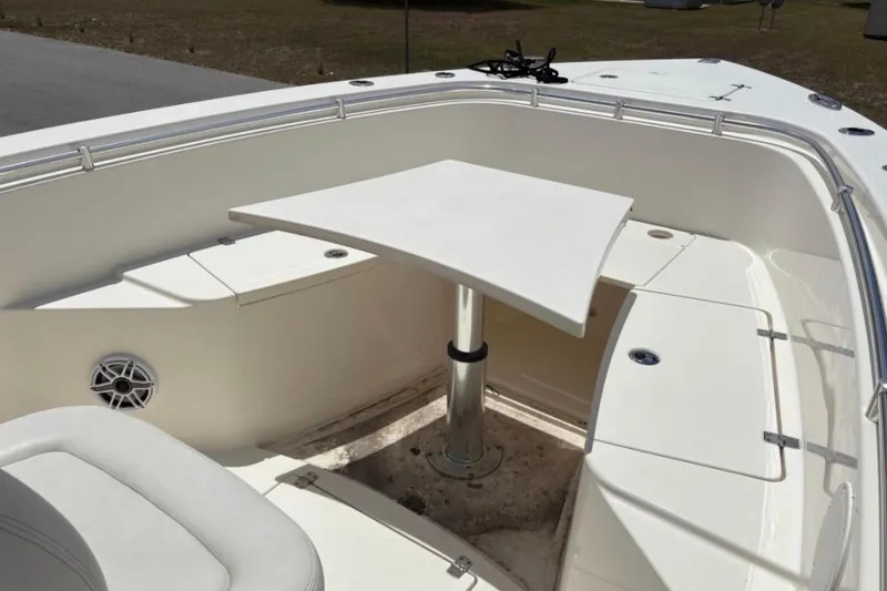 Slide: The Image of 2022 Cobia 301 Center Console boat interior with seating and table setup. - 10
