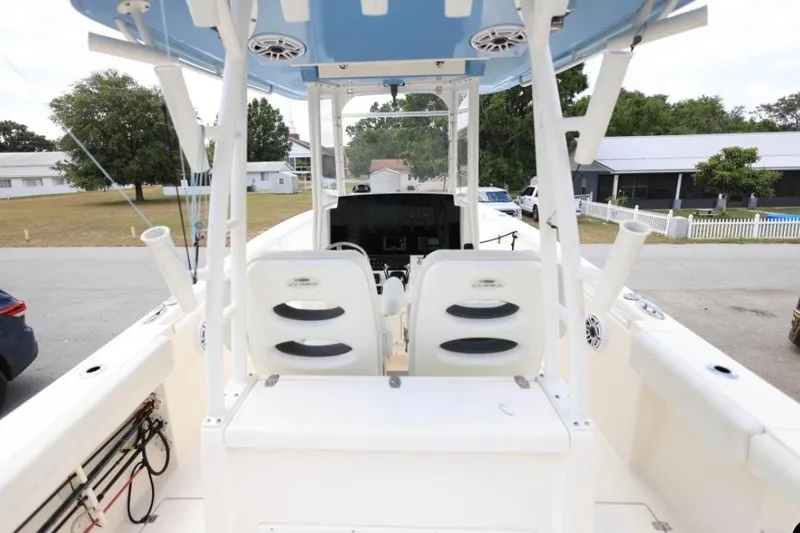 Slide: The Image of 2022 Cobia 301 Center Console boat interior with dual seats and fishing rod holders. - 6