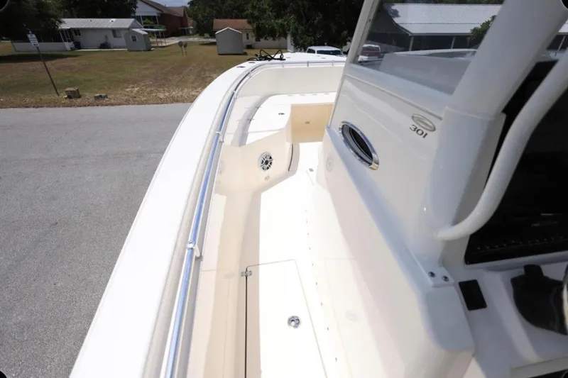 Slide: The Image of 2022 Cobia 301 Center Console boat deck, showcasing sleek design and spacious layout. - 8