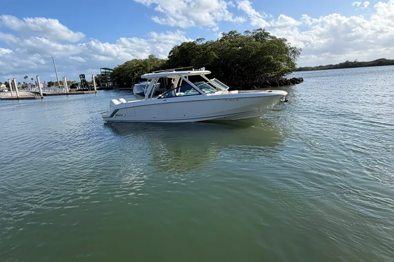 The Image of 2022 Boston Whaler 320 Vantage boat cruising on a sunny day. - 0