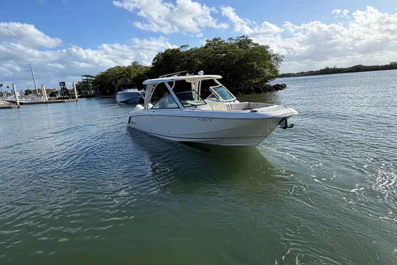 Slide: The Image of 2022 Boston Whaler 320 Vantage boat on calm water under a blue sky. - 1