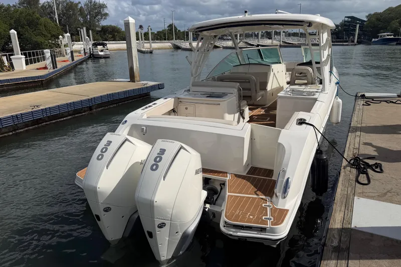 Slide: The Image of 2022 Boston Whaler 320 Vantage docked, featuring dual Mercury 300 engines. - 12