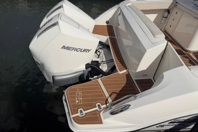 Slide: The Image of 2022 Boston Whaler 320 Vantage with dual Mercury engines, docked on water. - 13