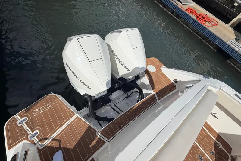 Slide: The Image of 2022 Boston Whaler 320 Vantage with dual Mercury engines, docked on water. - 14