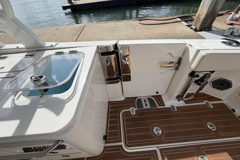 Slide: The Image of 2022 Boston Whaler 320 Vantage boat interior with teak flooring and storage compartments. - 21