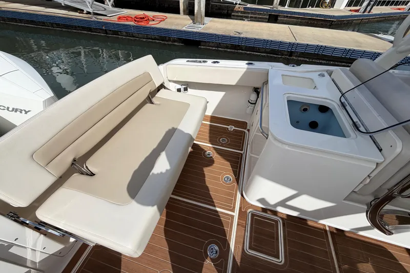 Slide: The Image of 2022 Boston Whaler 320 Vantage boat interior with seating and sink area. - 22