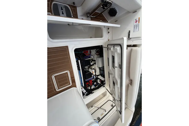 Slide: The Image of Open hatch of 2022 Boston Whaler 320 Vantage showing interior components and storage. - 23