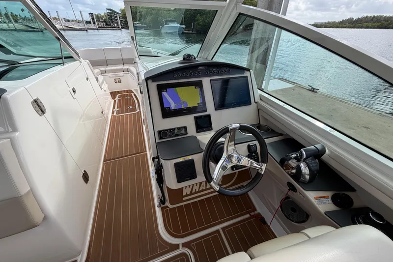 Slide: The Image of 2022 Boston Whaler 320 Vantage helm with navigation screens and steering wheel. - 27