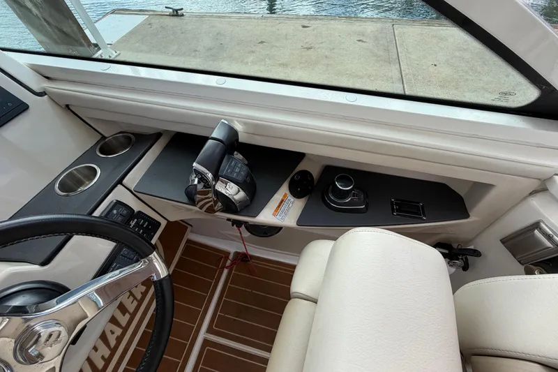 Slide: The Image of Interior view of 2022 Boston Whaler 320 Vantage boat cockpit with controls and steering wheel. - 29