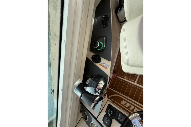 Slide: The Image of Control panel of a 2022 Boston Whaler 320 Vantage boat interior. - 30