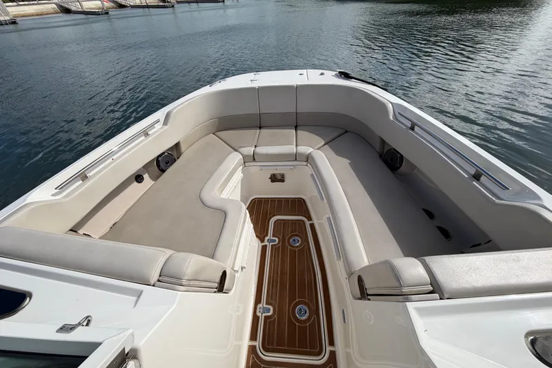 Slide: The Image of 2022 Boston Whaler 320 Vantage boat interior with cushioned seating and wooden flooring. - 37