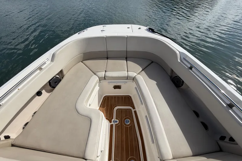 Slide: The Image of 2022 Boston Whaler 320 Vantage boat interior with cushioned seating and wooden flooring. - 38