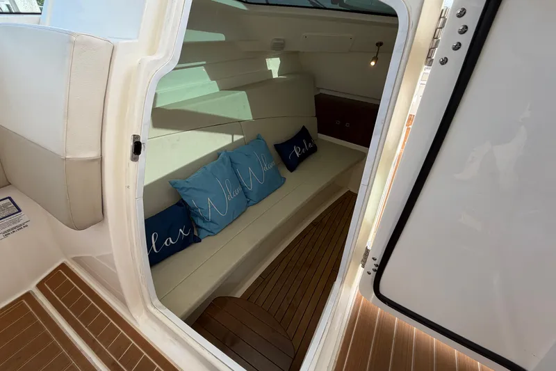 Slide: The Image of Interior cabin of 2022 Boston Whaler 320 Vantage with cushions and wooden flooring. - 42