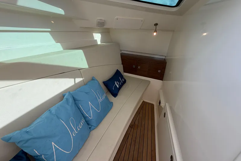 Slide: The Image of Interior of 2022 Boston Whaler 320 Vantage with cozy seating and welcome pillows. - 44