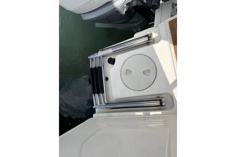 Slide: The Image of 2022 Boston Whaler 320 Vantage swim platform with ladder and water view. - 48