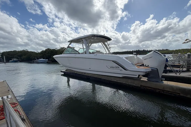Slide: The Image of 2022 Boston Whaler 320 Vantage boat docked on a sunny day. - 7
