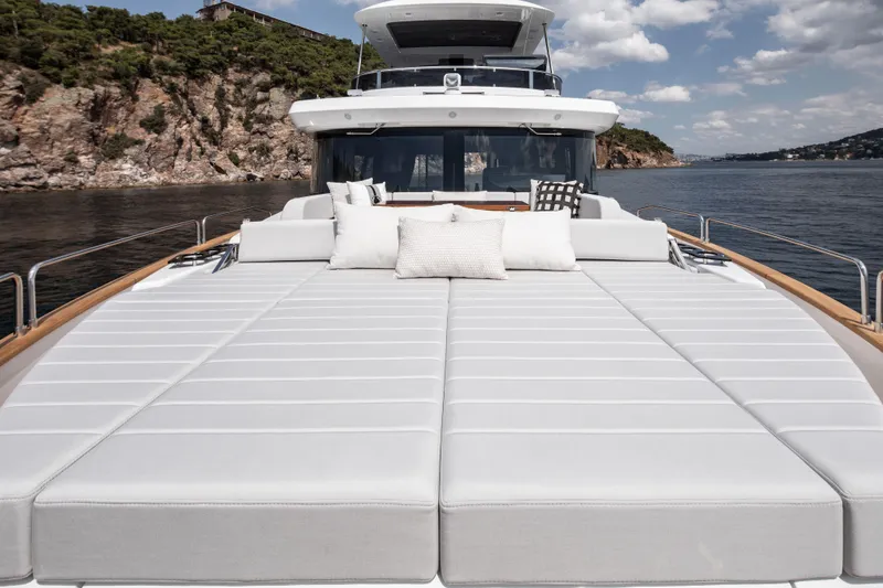 Slide: The Image of Luxurious 2026 Sirena 60 yacht with spacious sun deck and scenic coastal view. - 11