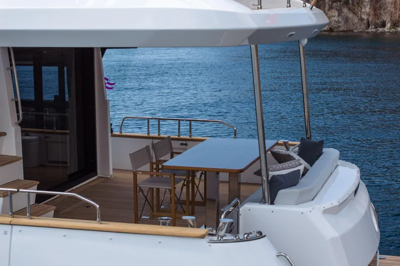 Slide: The Image of Luxurious Sirena 60 yacht deck with seating, table, and ocean view, 2026 model. - 15