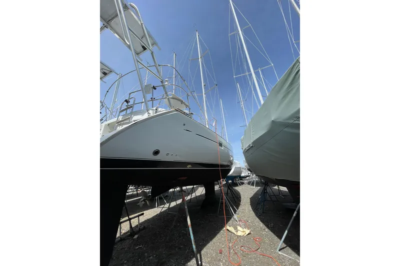 Slide: The Image of 2004 Beneteau 423 sailboat on dry dock, surrounded by other boats. - 4