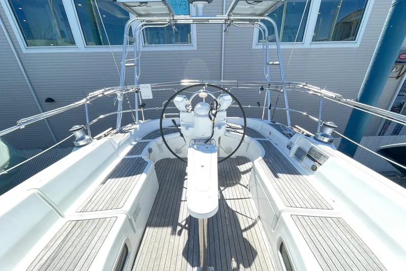 Slide: The Image of Cockpit view of 2004 Beneteau 423 sailboat with steering wheel and seating. - 7