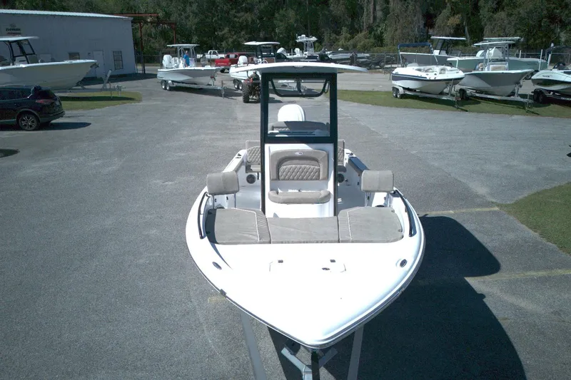 Slide: The Image of 2026 Sea Hunt BX 25 FS boat displayed in a marina with other vessels. - 12