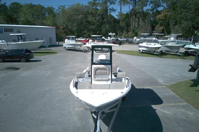 Slide: The Image of 2026 Sea Hunt BX 25 FS boat displayed in a marina with surrounding boats. - 2