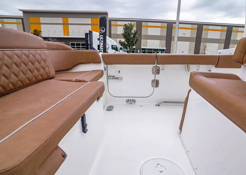 Slide: The Image of Interior of Sea Hunt Ultra 265 SE 2026 with brown seating. - 8