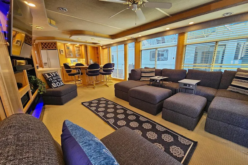 Slide: The Image of Luxurious 2001 Sumerset 16x79 houseboat interior with plush seating and modern decor. - 11