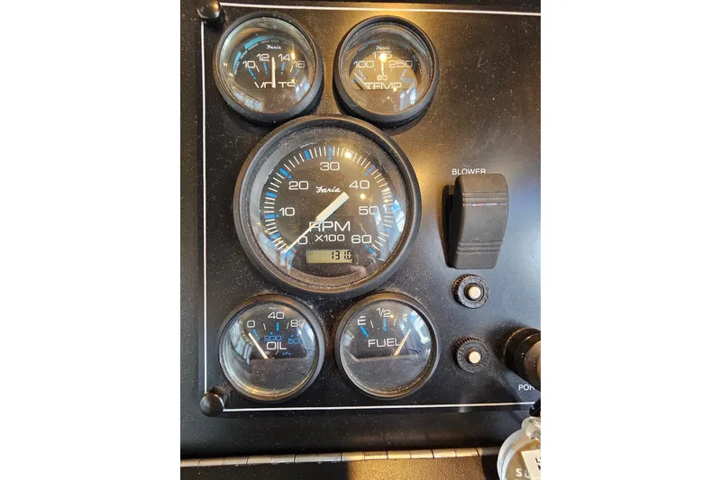 Slide: The Image of Instrument panel of a 2001 Sumerset 16x79 houseboat with RPM, voltage, and fuel gauges. - 13