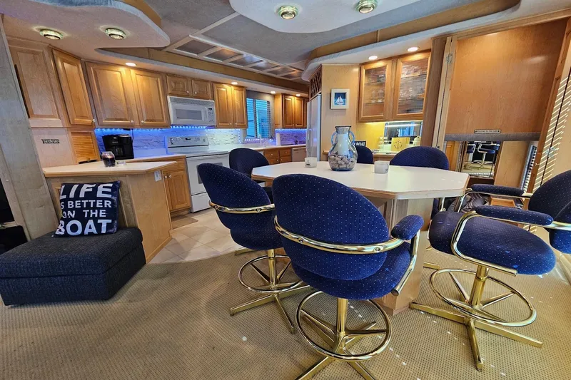 Slide: The Image of Luxurious 2001 Sumerset 16x79 houseboat interior with kitchen and dining area. - 16