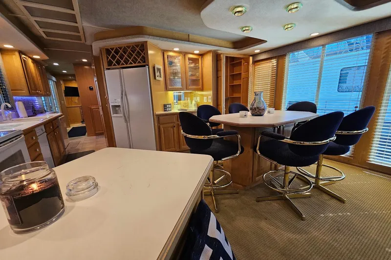 Slide: The Image of Luxurious 2001 Sumerset 16x79 houseboat interior with modern kitchen and dining area. - 17