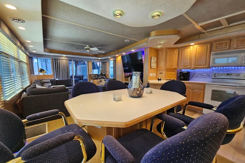 Slide: The Image of Luxurious 2001 Sumerset 16x79 houseboat interior with modern kitchen and cozy seating area. - 19